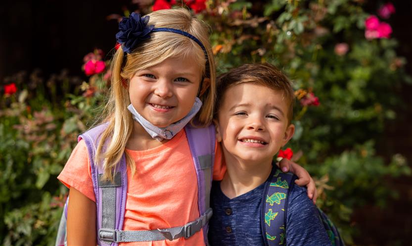 Two students smile